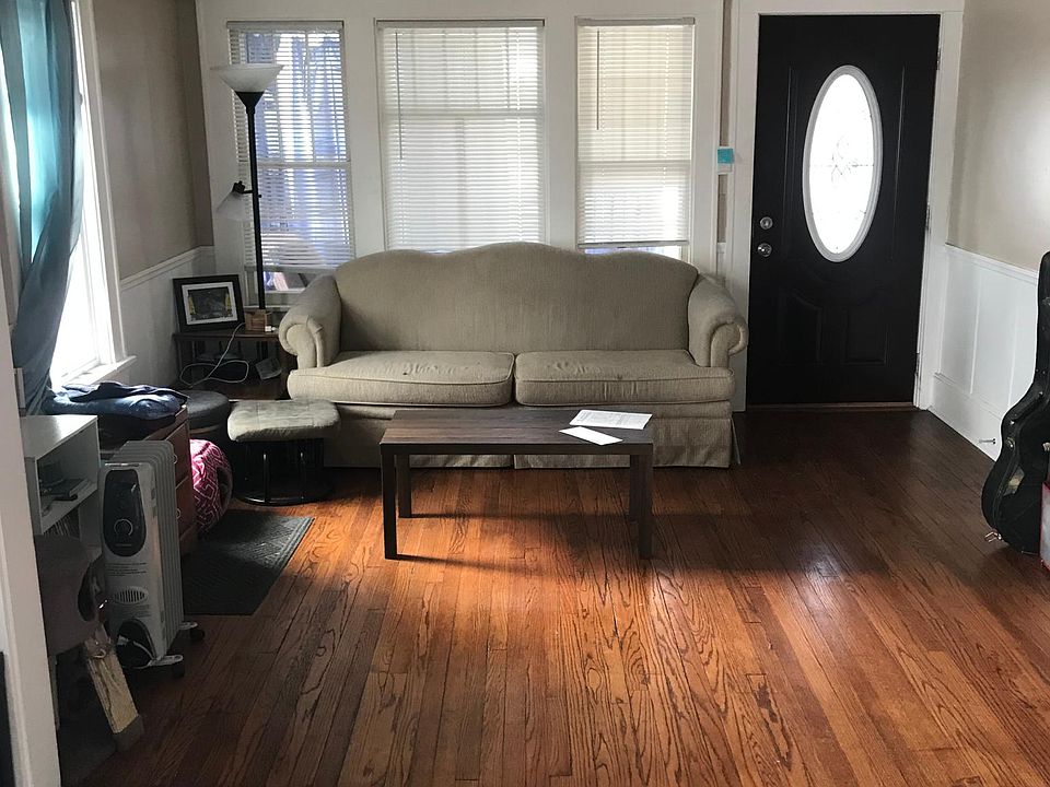 Hardwood floors throughout living area with lots of windows for natural light
