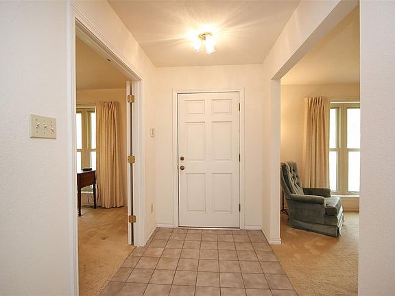 Front entry with study/home office to left and formal living to right.