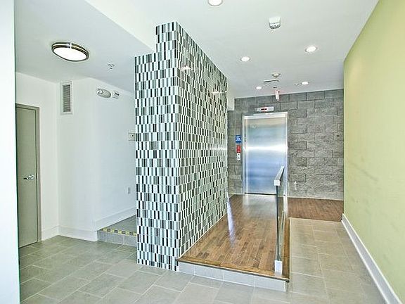 Beautiful glass tile and wood floors in the buildings entrance.