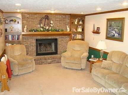 Living room with gas fireplace and built-in book shelves.