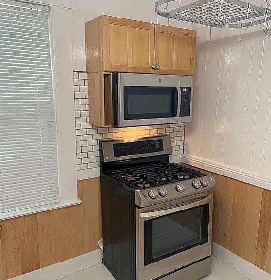New kitchen stove, microwave and convection oven with pot rack