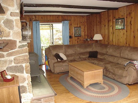 Living Room w/ Hardwood Floors, Beam Ceiling, Wet Bar, Skylite & Patio Sliders