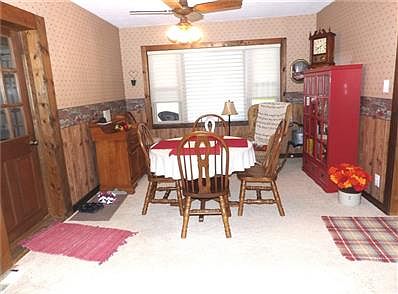 Large living room with newer carpet, large picture window.