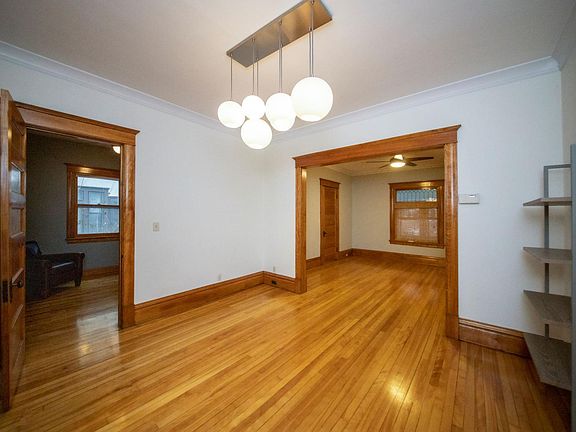 Formal dining area with built-in CB2 shelving, and color-changing smart light bulbs in fixture!