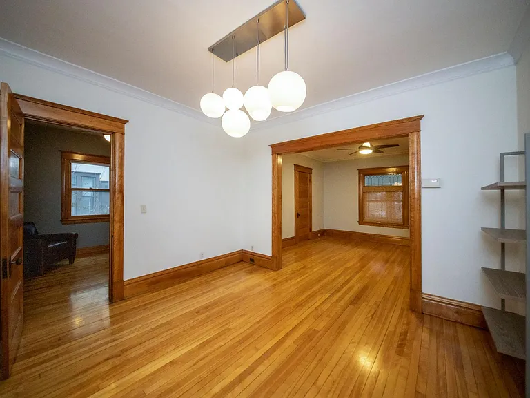 Formal dining area with built-in CB2 shelving, and color-changing smart light bulbs in fixture!
