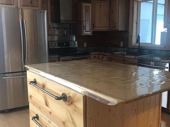 Kitchen island/bar on wheels with storage for appliances, silverware or food.