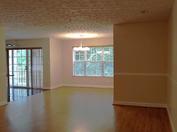 Living Room into Dining Room with view of trees