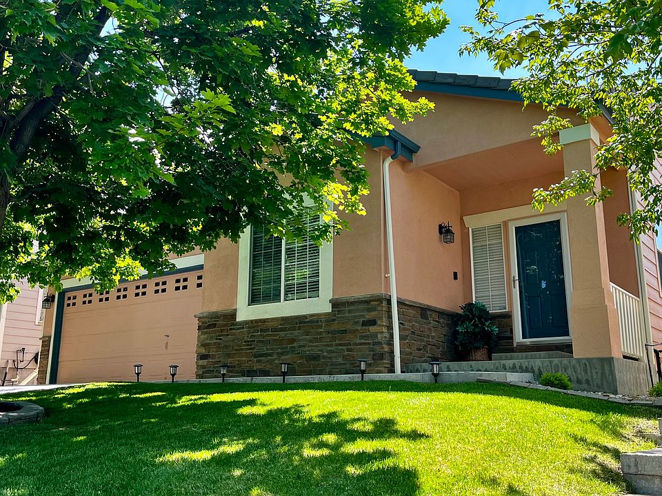 Convenient ranch-style living with two huge trees in the front yard.
