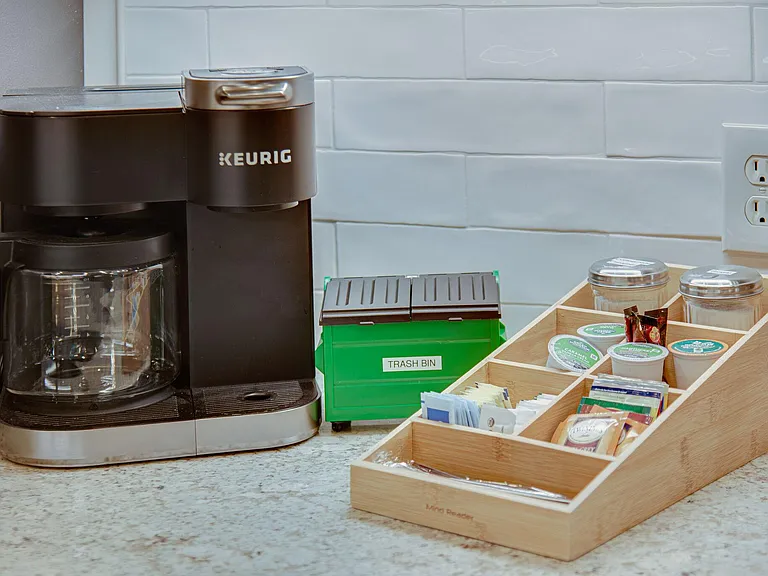 Coffee station complete with pods, creamers, sugars, tea