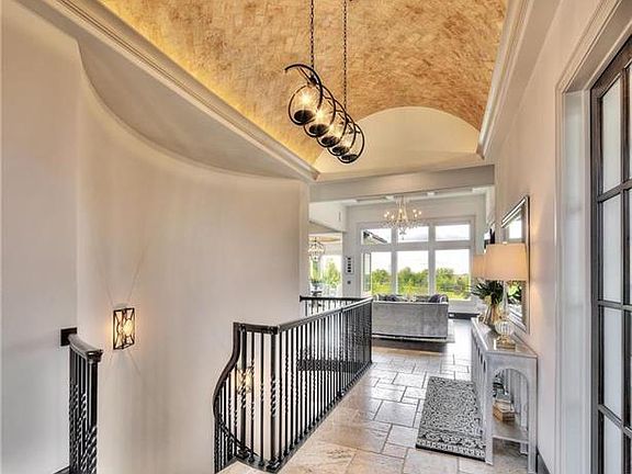 Stunning entry w/ vaulted barrel ceiling custom painted by an artist.