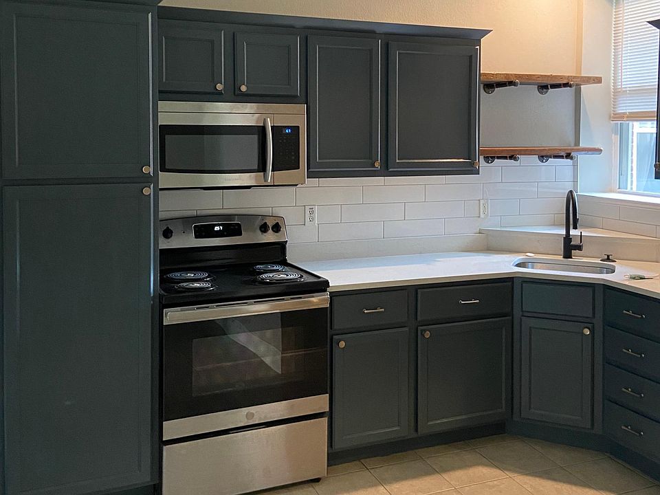 Beautiful cabinets with quartz countertops, brushed champaign hardware, reclaimed wood open shelving, stainless steal appliances