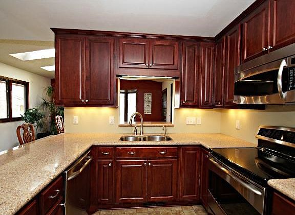 Updated kitchen with ss/appliances, custom cabinets, and granite breakfast bar.