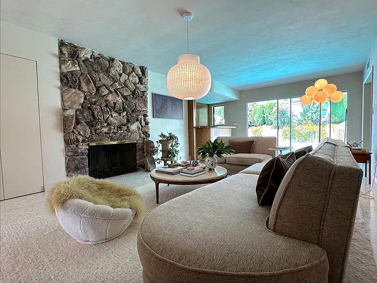 Second living room adjacent to bar and kitchen. Also features Samsung gallery frame TV
