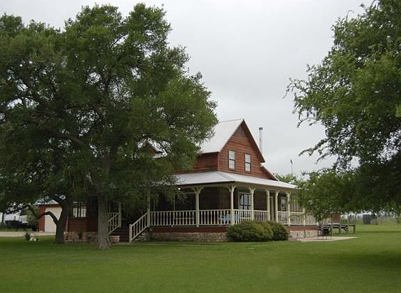 Enjoy the views and the mature trees from the wrap-around porch.
