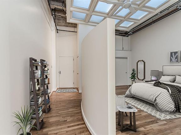 True Loft living in historic Bayou Lofts. Located on the second floor with 14' ceilings, hardwood floors, ensuite bedroom and open concept Living/Dining and Kitchen. Bedroom and entry virtually staged.