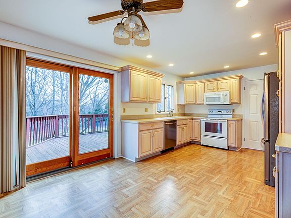 Eat-in-kitchen with laundry area leads to deck