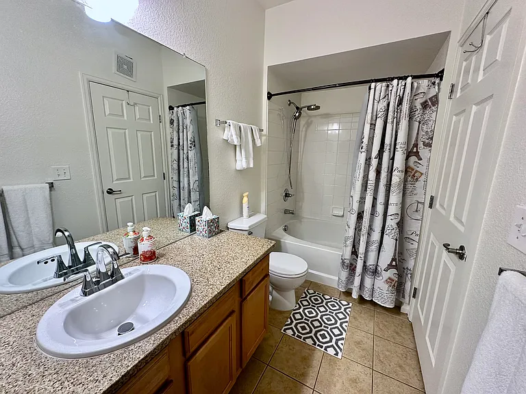 Master bathroom with extra large bathtub and linen closet.