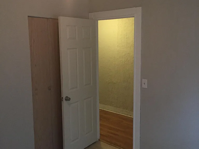 1st bedroom near the entrance with windows to street and small closet