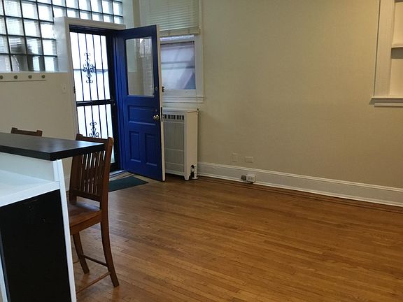 From the living/dining room looking toward the door, eating bar & kitchen to the left, fireplace to the right.
