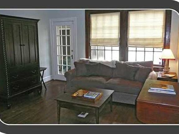 Spacious living room with lots of light and gorgeous stained wood window
