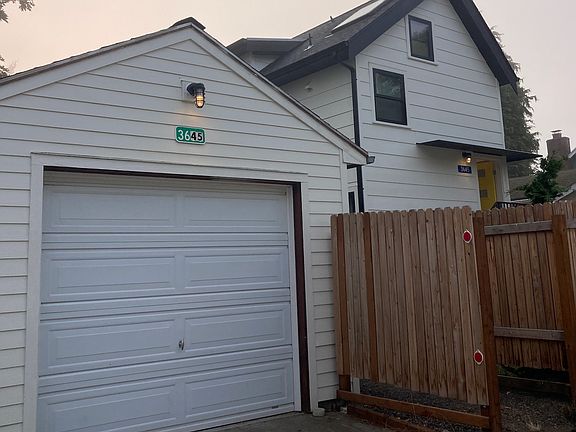 SKY HOUSE Approach from alley. Detached 300' square garage is included in rental.