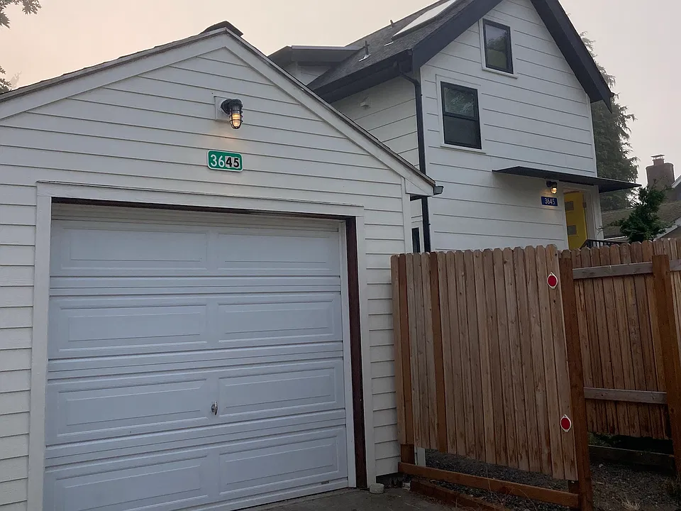 SKY HOUSE Approach from alley. Detached 300' square garage is included in rental.