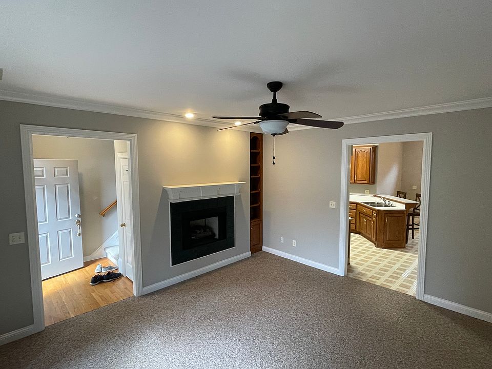 Gas log fireplace, built in shelving, hardwood entry