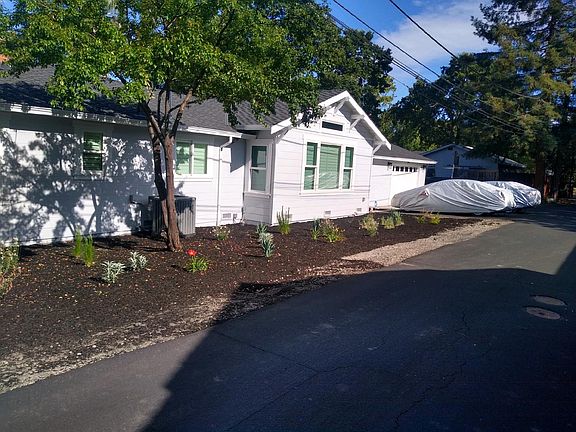 Side yard along Shasta Lane, driveway parking and garage.