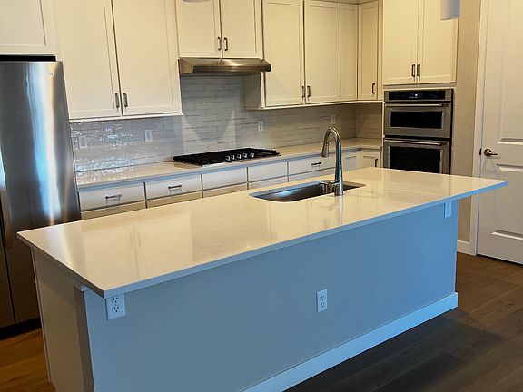 Kitchen with dishwasher stove oven microwave refrigerator. Plenty of cabinets space.
