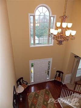 Beautiful two story foyer with hardwood flooring.