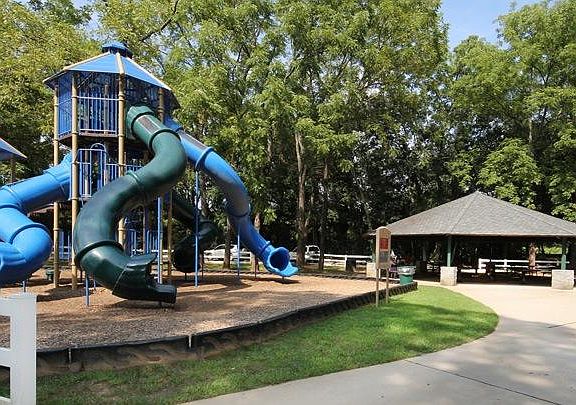 Kids playground is in the park behind the house