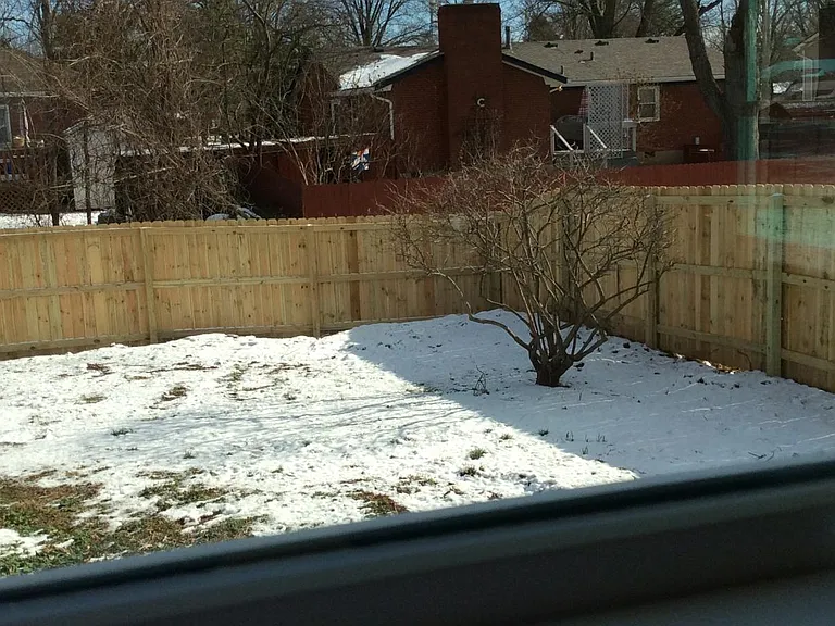 Private backyard with deck and enclosed porch. Access to one car detached garage.