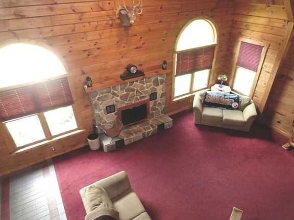 Featuring a cathedral ceiling and circle top windows.