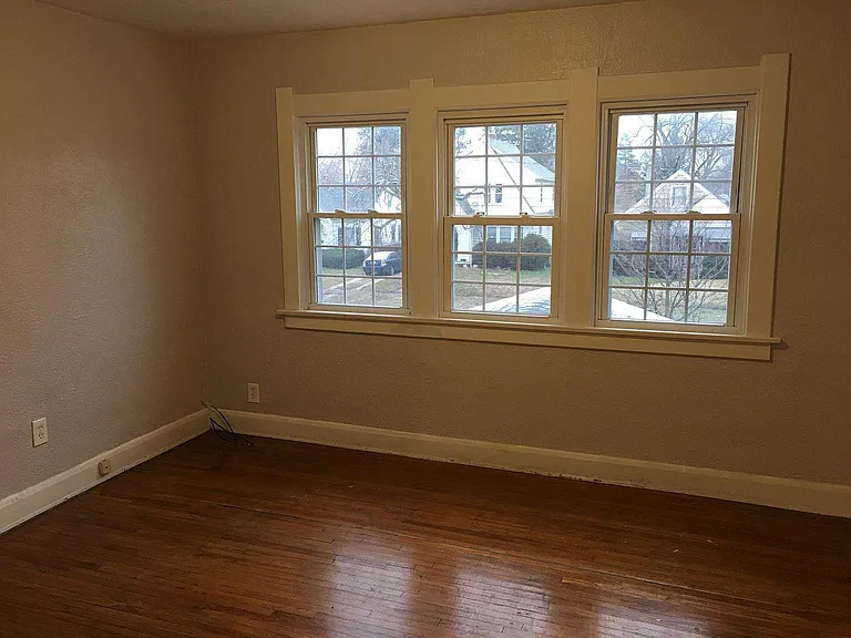 Bedroom #1 with large beautiful insulated windows and hard wood flooring