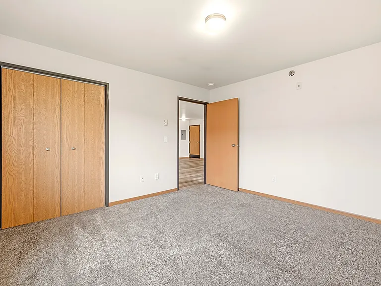 Step into the spacious living area of Paramount at the Bluffs Apartments, showcasing modern design with ample natural light. Enjoy a versatile layout perfect for your creative touches. Schedule a tour today and envision your new home!