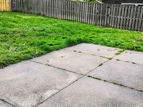 Secure fenced in back yard with shed and concrete patio!