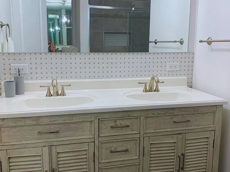 Spacious Vanity with Elegant Mirror & Cabinets.