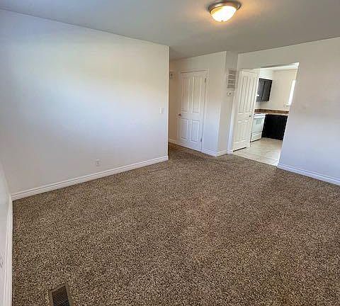 Living room with view of kitchen and hall