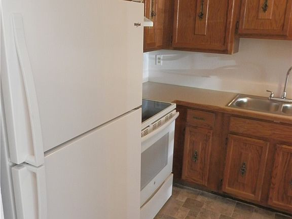Hall is behind you.  Switch the hings on this new refriferator so the doors open into the kitchen area.  