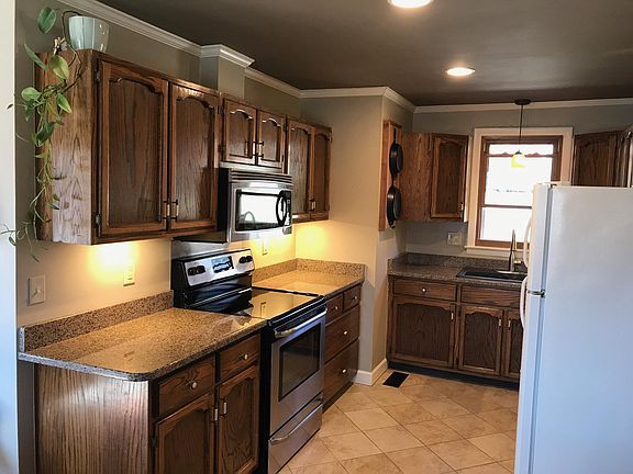 The kitchen is open to the dining and living room. Under cabinet lighting brightens up the countertops and a window over the sink looks out to the beautiful back yard.