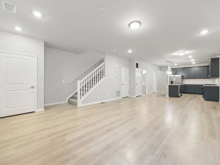 Bright and open layout with recessed lighting and tall ceilings