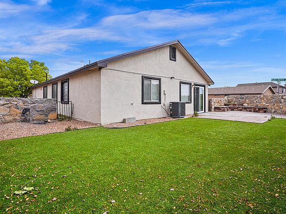 Backyard with landscaping and low maintenance artificial grass