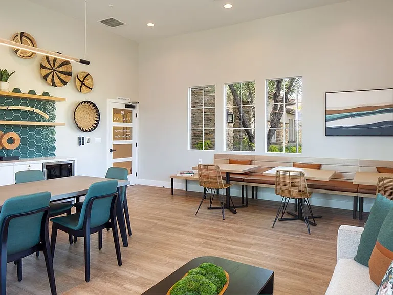 Resident lounge with entertaining kitchen, dining area, and lounge seating