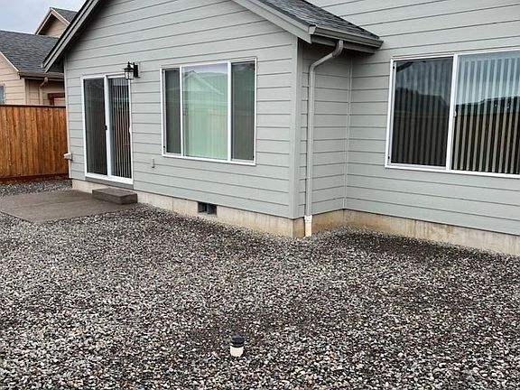 Rocked back yard with concrete patio.