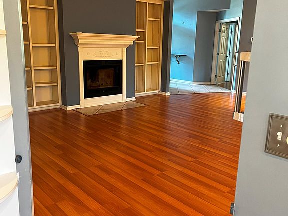 Large, open air great room with fireplace and large bookshelves