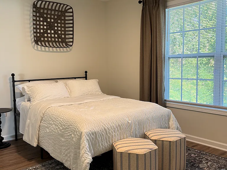 Staged bedroom from model unit. Easily fits queen size bed or can be used as an at home office/work from home space.