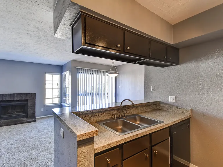 Comfortable bedroom with ceiling fan and large windows for natural light and year-round comfort.