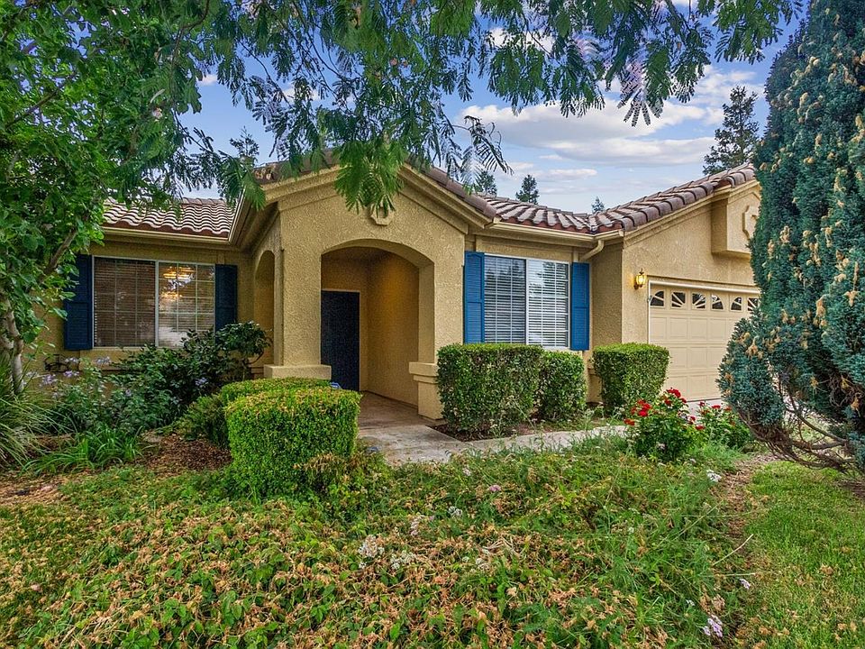 Great home with tile roof and mature landscaping.