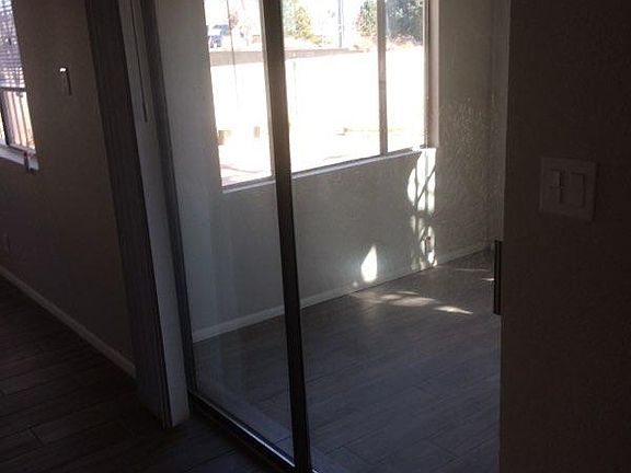 sliding glass door to enclosed sun room/ office