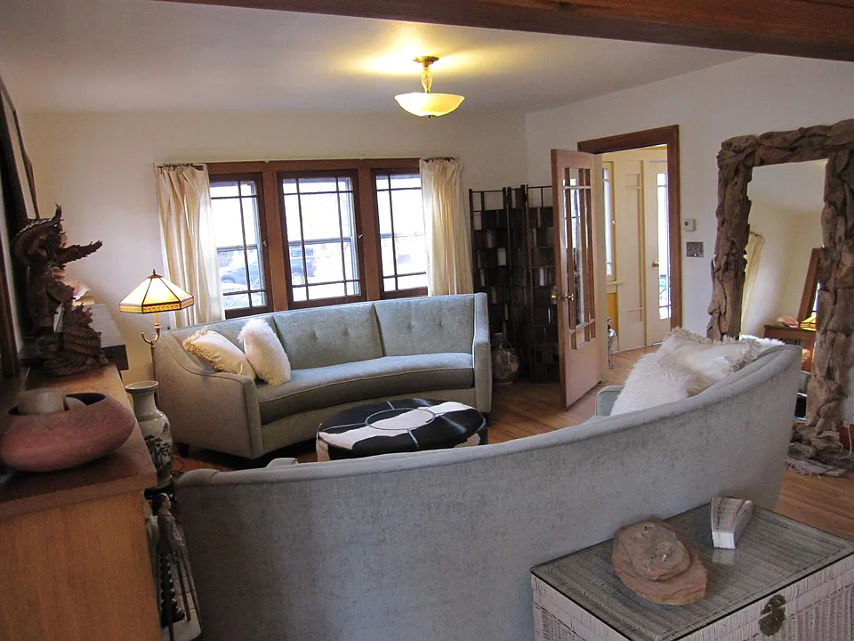 Living room with windows looking out to front of house.